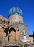 The Gūr-e Amīr or Guri Amir (Persian: گورِ امیر) is the mausoleum of the Asian conqueror Tamerlane (also known as Timur) in Samarkand, Uzbekistan. It occupies an important place in the history of Persian Architecture as the precursor and model for later great Mughal architecture tombs, including Humayun's Tomb in Delhi and the Taj Mahal in Agra, built by Timur's descendants, the ruling Mughal dynasty of North India. It has been heavily restored.<br/><br/>

Gur-e Amir is Persian for 'Tomb of the King'. This architectural complex with its azure dome contains the tombs of Tamerlane, his sons Shah Rukh and Miran Shah and grandsons Ulugh Beg and Muhammad Sultan. Also honoured with a place in the tomb is Timur's teacher Sayyid Baraka.